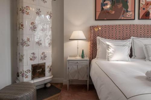 a bedroom with a bed and a table with a lamp at The Sparrow Hotel in Stockholm