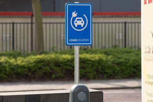 a blue sign on a pole on a street at Shanghai Hotel Holland in Delft