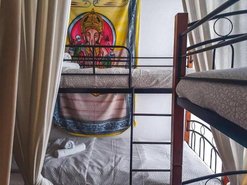 a bunk bed with a painting on the wall at Urban Yoga House Hostel & Retreat in Ioannina