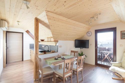 a kitchen and dining room with a table and chairs at Apartments Katja in Bohinj