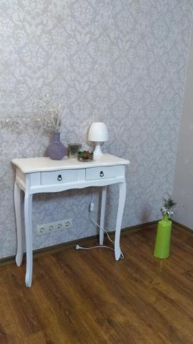 a white table with a lamp on top of it at 1кім в Центрі,вул.Набережна in Rivne