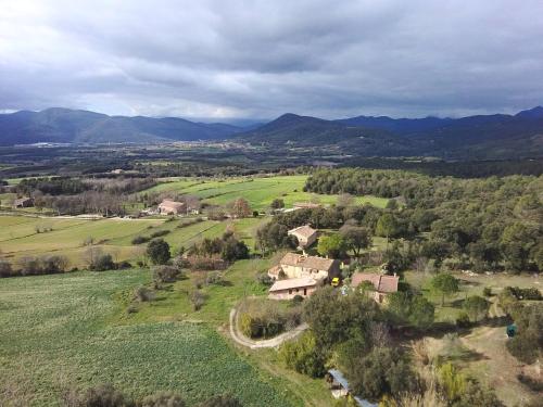 an aerial view of a house in a field at Mas Ca La Coixa in Tortellá