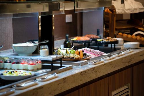 a buffet line with many different types of food at Crowne Plaza London Heathrow T4 by IHG in Hillingdon