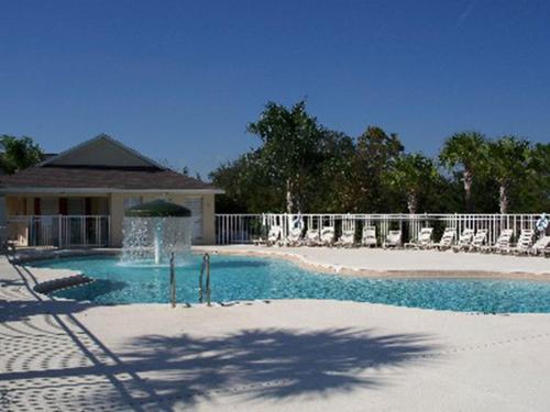 a swimming pool with chairs and a fence at A wonderful choice for a family Vacation, 4 bedrooms and it own pool in Orlando