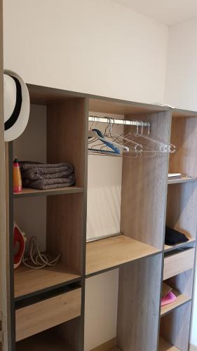 a closet with wooden shelves at Le lodge origin in Sainte-Suzanne