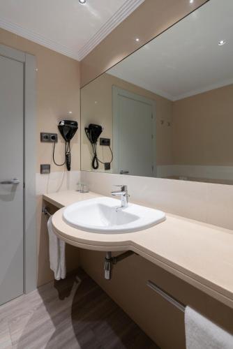 a bathroom with a sink and a large mirror at Attica 21 Barcelona Mar in Barcelona