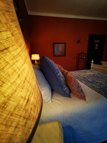 a bedroom with a bed with blue pillows at Monte Alerta Turismo Rural in Monsaraz