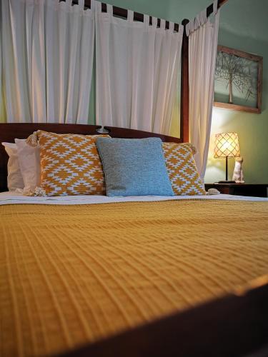a bedroom with a bed with orange sheets and pillows at Monte Alerta Turismo Rural in Monsaraz