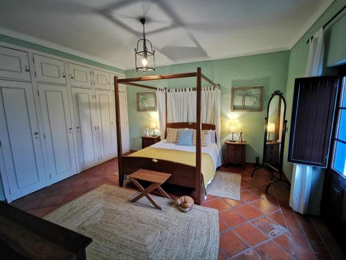 a bedroom with a canopy bed in a room at Monte Alerta Turismo Rural in Monsaraz