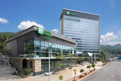 a large building with a sign on top of it at Holiday Inn Shaoguan Downtown by IHG in Shaoguan