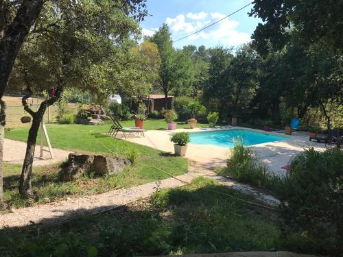une cour arrière avec piscine et arbres dans l'établissement la campagne de Mari, à Peyrolles-en-Provence