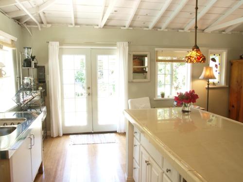 a kitchen with a counter and a kitchen with a sink at Culver City Escape with Pool, Near Disneyland Park! in Los Angeles