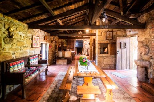 a living room with a wooden table in a building at Moinho de Estoraos in Ponte de Lima