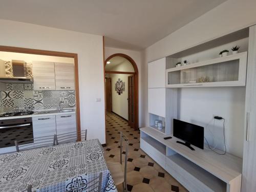 a kitchen with a bed and a tv in a room at Villa Boito in Marina di Pescoluse