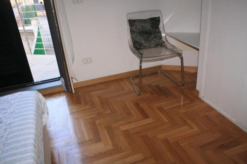 a chair sitting in a room with a wooden floor at TataBlu residenza con parcheggio in Florence