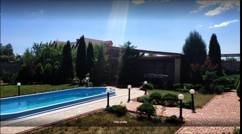 a swimming pool in the yard of a house at Villa Costa in Sanzhiyka