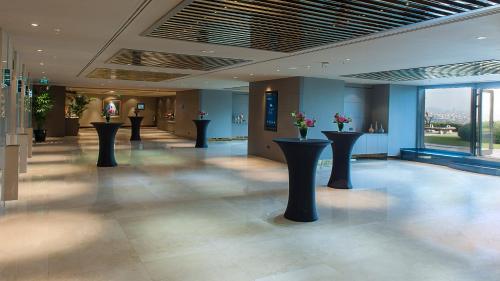 a lobby with black pillars with flowers on them at InterContinental Istanbul, an IHG Hotel in Istanbul