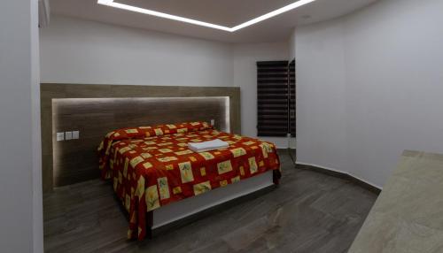 Postel nebo postele na pokoji v ubytování Hotel Galería del Ángel