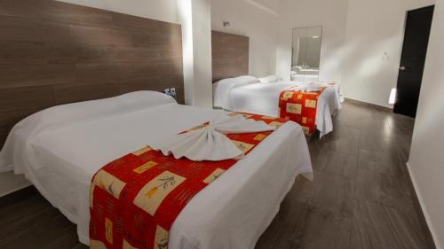Postel nebo postele na pokoji v ubytování Hotel Galería del Ángel