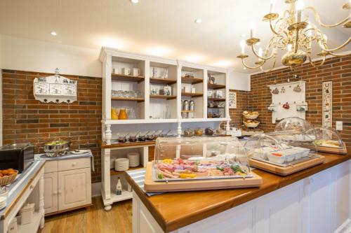 a kitchen with a counter with some food on it at Hotel Das kleine Glück - Adults Only in Sankt Peter-Ording