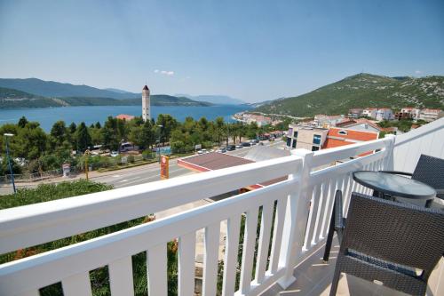 a balcony with chairs and a view of the water at Villa Doris in Neum