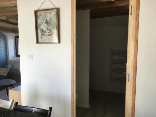 a door into a room with a picture on the wall at Arlequin in Amboise