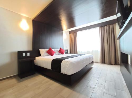 Una cama o camas en una habitación de Hotel La Estancia Zacatlan