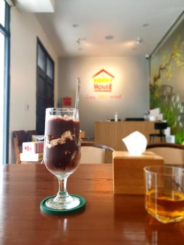 a drink in a glass sitting on a table at Merry House Imperia in Hai Phong