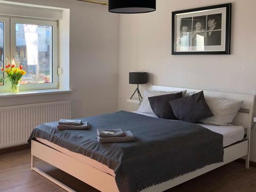 a bedroom with a bed with two towels on it at Landlust Hotel in Gransee