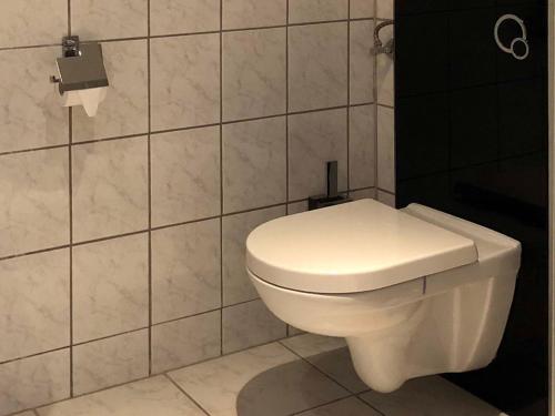a bathroom with a white toilet in a room at Landlust Hotel in Gransee