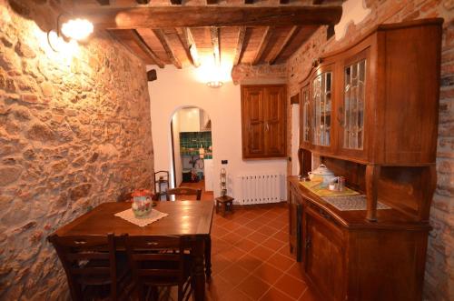 a kitchen with a table and a dining room at La Divina Dimora Il Castello degli Spiriti Magni in Montepescali
