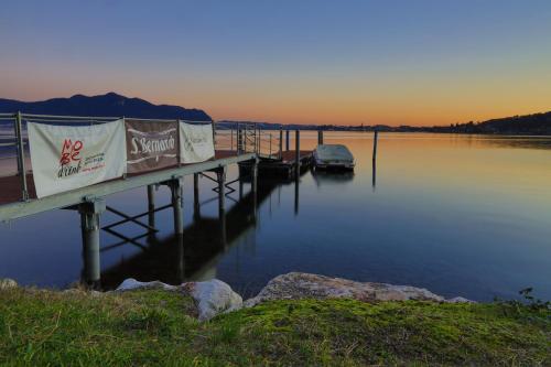 a dock with a boat in the water at Cocca Hotel Royal Thai Spa in Sarnico