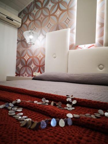 a bedroom with a bed with a bead necklace on the floor at Paradise Vezal in Laganas