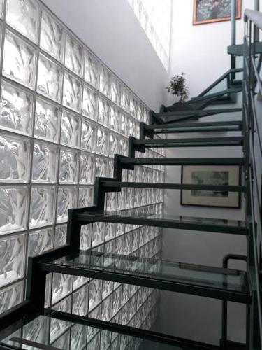 a staircase in a room with a tile wall at la gatta sul sentiero in San Salvatore