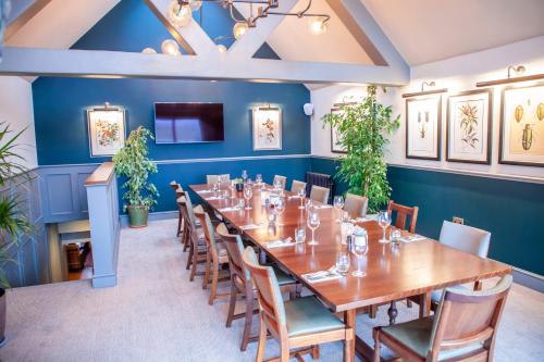 a large dining room with a long table and chairs at The Bell - Brunning and Price in Alderminster