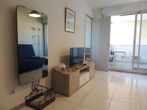a living room with a flat screen tv on a wall at Cathymini à Sete in Sète