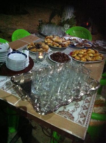 a table topped with plates and bowls of food at Ferme D"Hote Lala Fatima in Aïn Leuh
