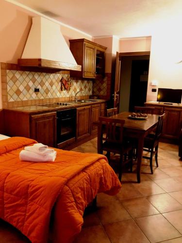 a kitchen with a bed and a table in a room at Residence Du Commerce in Oulx