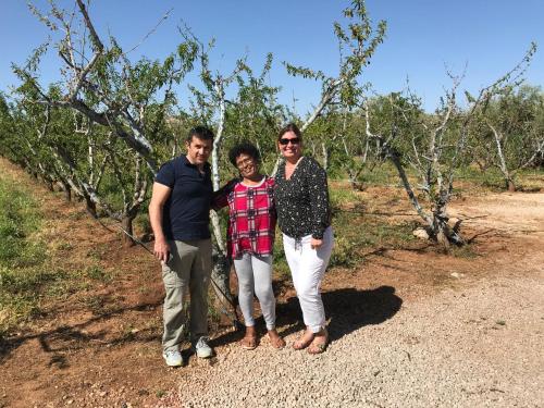a group of three people standing in front of trees at Ferme D"Hote Lala Fatima in Aïn Leuh