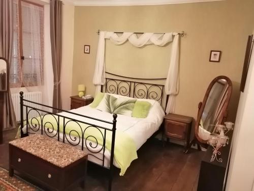 a bedroom with a bed and a mirror at Vingt Grand Rue in Champagne-Mouton