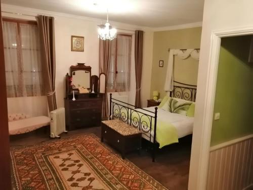 a bedroom with a bed and a mirror at Vingt Grand Rue in Champagne-Mouton