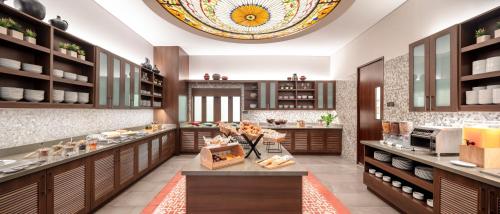 a large kitchen with wooden cabinets and a ceiling at Hyatt Place Bogota Convention Center in Bogotá