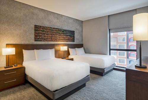 a hotel room with two beds and a window at Hyatt Place Bogota Convention Center in Bogotá