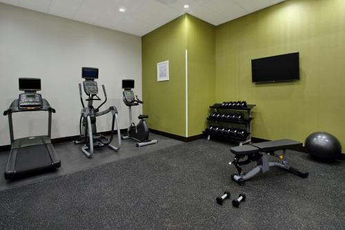 a gym with several exercise bikes and a flat screen tv at Holiday Inn Hattiesburg - North by IHG in Hattiesburg