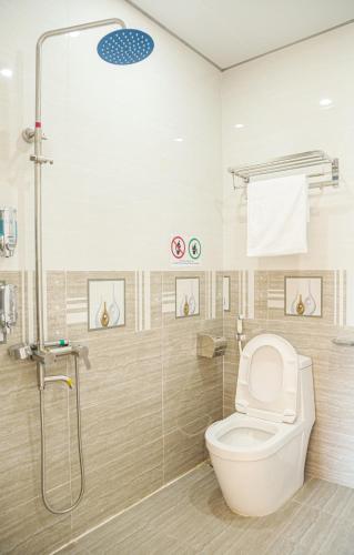 a bathroom with a toilet and a shower at Tigon Flower House 2 in Da Lat