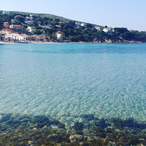 a large body of water with a beach in the background at La spiaggetta Maladroxia in Maladroxia