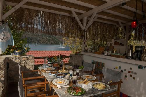 a long table with plates of food on it at Valentina Boutique Hotel in Bozburun