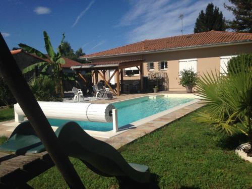 a swimming pool in front of a house at Verolithos in Narrosse