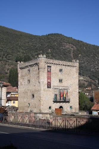 a large stone building on the side of a road at Hostería La Antigua in Potes