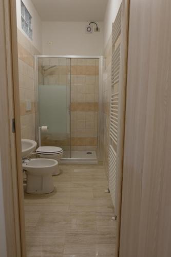 a bathroom with a toilet and a sink and a shower at B&B LUNA in Seriate